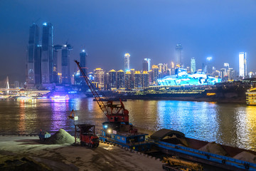 Wharf crane at work, night view of modern urban architecture, chongqing, China