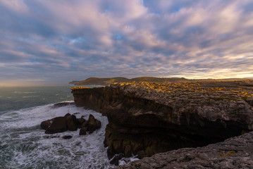 Rocky coast of Ajo Cape at sunset, Cantabria, Spain