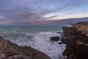 Rocky coast of Ajo Cape at sunrise, Cantabria, Spain