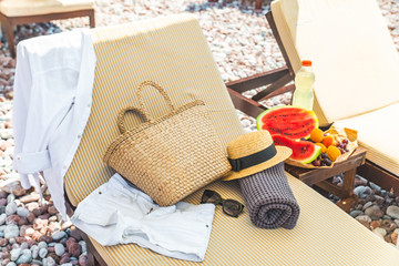 beach stuff bag towel blanket on sun longer. fruits on the table. summer vacation