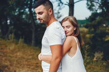 Fototapeta premium Beautiful couple spend time in a summer park