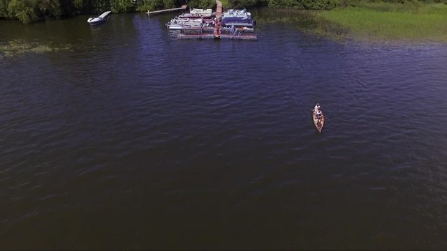 Aerial drone shot of a family paddling a canoe on Lake Irving, in Bemidji, Minnesota.