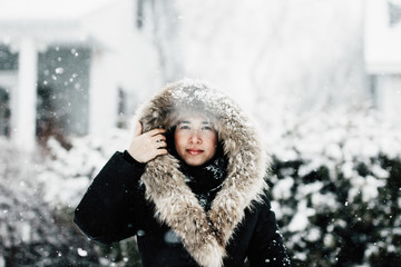 Asiatic woman enjoying a winter storm outdoor