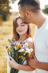 Beautiful couple spend time in a summer park