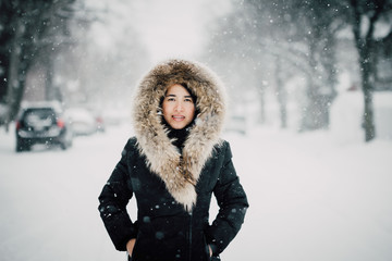 Asiatic woman enjoying a winter storm outdoor