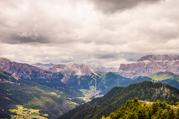 Fototapeta premium Alpe di Siusi, Seiser Alm with Sassolungo Langkofel Dolomite, a view of a large mountain in the background