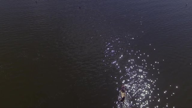 Couple rowing a canoe from a dock on Lake Irving.