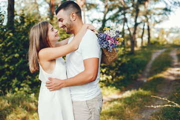 Beautiful couple spend time in a summer park
