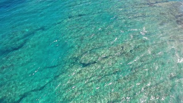 Aerial view over the coral reefs of Reunion Island and its turquoise waters.