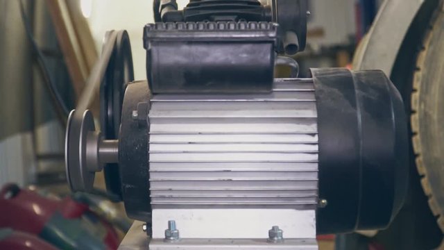 A mechanic repairs a part for a car or truck close up