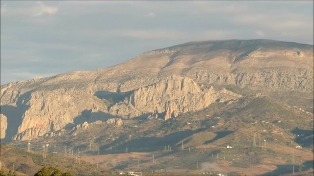 Rocky outcrop of Sierra Huma viewed across valley in Andalusian countryside
