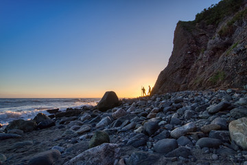 Fototapeta na wymiar Men Near Dana Point Cliff at Sunset