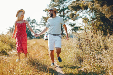 Fototapeta premium Beautiful couple spend time in a summer park