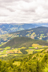 Obraz premium Alpe di Siusi, Seiser Alm with Sassolungo Langkofel Dolomite, a view of a large mountain in the background