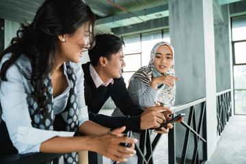 group of office friends chatting about most trending topic in the world