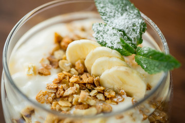 dessert with fresh cream, nuts and banana