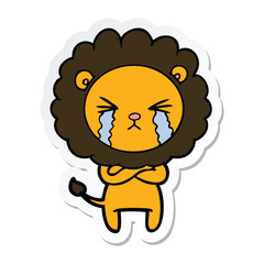 sticker of a cartoon crying lion with crossed arms