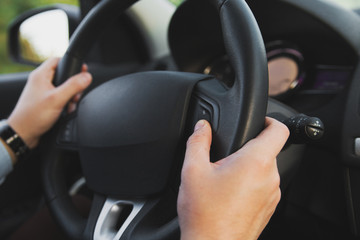 Man driving a vehicle. Hand with rudder