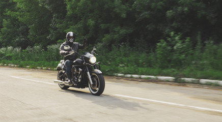 Obraz na płótnie Canvas slow motion, biker riding unknown motorbike with blur movement, speed concept