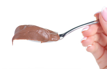 spoon with chocolate spread in hand on white background isolation