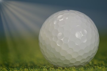 golf ball on the green with sunbeams
