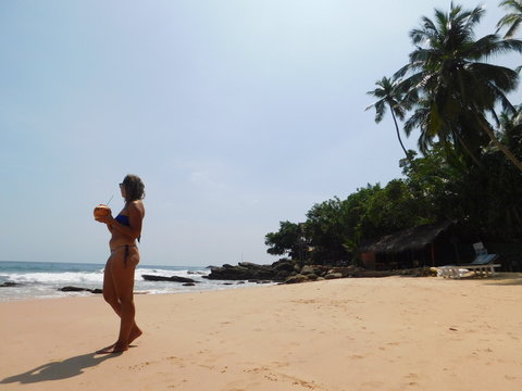 young woman walking on the beach