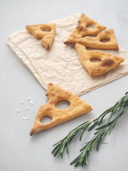 Salty cookies in the shape of cheese slice. Party appetizer. Vertical. High view.Selective focus.