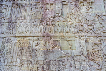 Fototapeta na wymiar Relief on the wall of gallery of Bayon temple in Angkor Thom. Cambodia