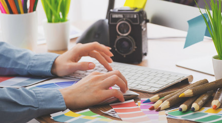 Young cute Graphic designer using graphics tablet to do his work at desk