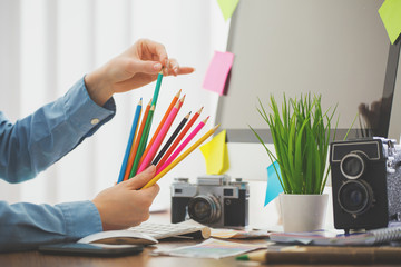 designer drawing something with a color pencils in a modern office