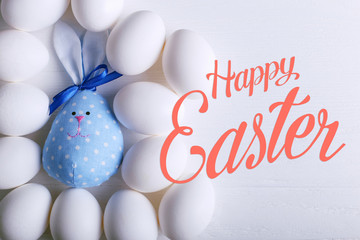 A number of eggs, including Easter bunny handmade. Text, happy easter.
