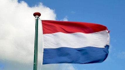 Slow motion of dutch flag blowing in a blue sky - Powered by Adobe