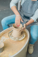 girl makes a jug of his own hands in a pottery workshop	