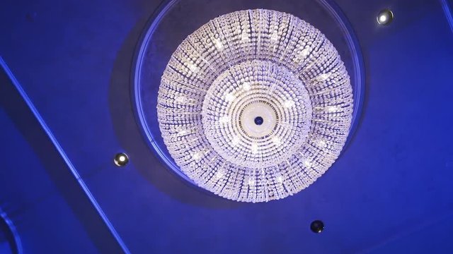 Large crystal chandelier on the ceiling of a banquet hall.