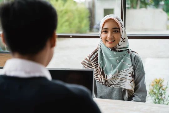 veiled women interviewed as new employees by the owner of the company in the midday