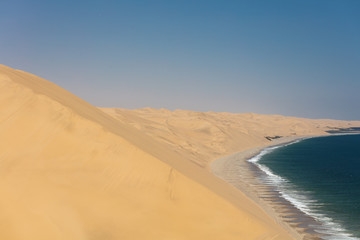 Fototapeta na wymiar Sandwich Harbour and the stunning dunes in Namibia during the Summer.