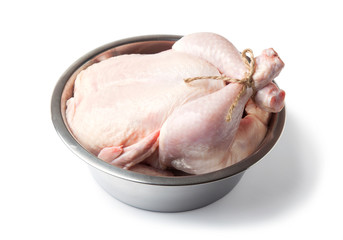 Raw, fresh, whole chicken metal bowl isolated on a white background.