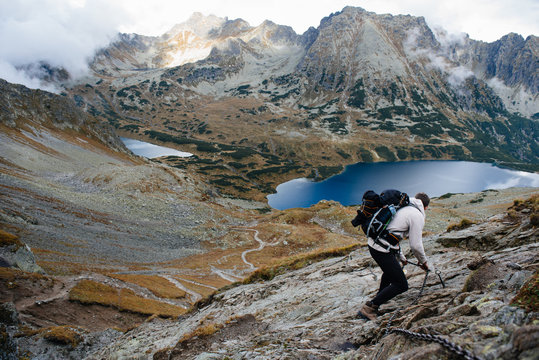 Male hiker with backpack standing on mountain