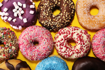 assorted donuts with chocolate frosted, pink glazed and sprinkles donuts