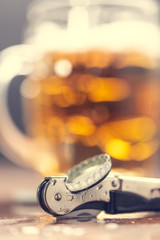 Bottle opener and beer on the bar.