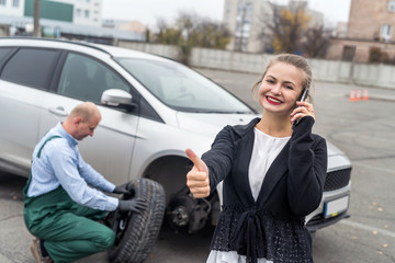 Happy woman with thumb up on car service