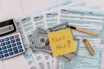 Naklejka premium 1040 form with dollars and need help text at table