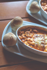Combinazione, an Italian dish combined with Lasagne, Spaghetti and tortellini dumplings baked in a dish. Shallow depth of field, noisy instagram filter.