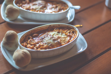 Combinazione, an Italian dish combined with Lasagne, Spaghetti and tortellini dumplings baked in a dish. Shallow depth of field, noisy instagram filter.