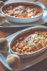 Combinazione, an Italian dish combined with Lasagne, Spaghetti and tortellini dumplings baked in a dish. Shallow depth of field, noisy instagram filter.