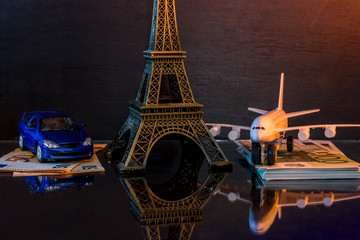 Travel concept with eiffel tower, toy car and plane
