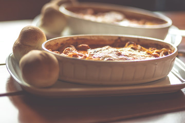 Combinazione, an Italian dish combined with Lasagne, Spaghetti and tortellini dumplings baked in a dish. Shallow depth of field, noisy instagram filter.