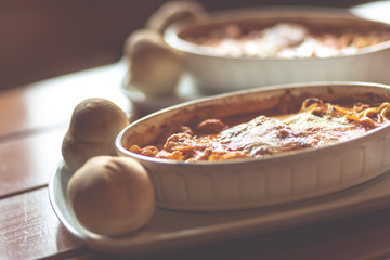 Combinazione, an Italian dish combined with Lasagne, Spaghetti and tortellini dumplings baked in a dish. Shallow depth of field, noisy instagram filter.