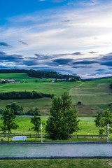 Alpe di Siusi, Seiser Alm with Sassolungo Langkofel Dolomite, a large green field with trees in the background