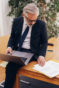 Businessman sitting working at an office table